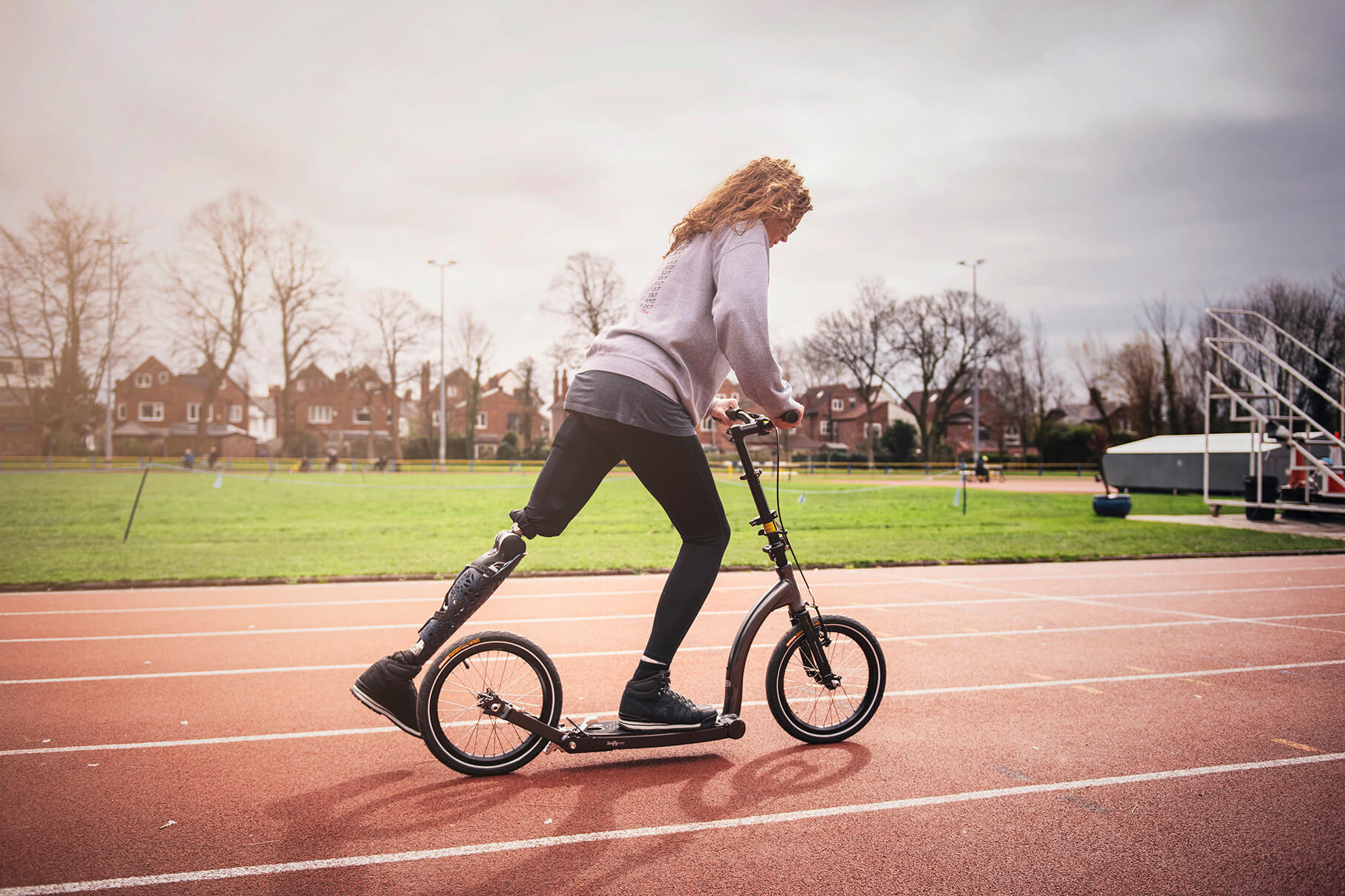 Amputee riding folding adult commuter scooter