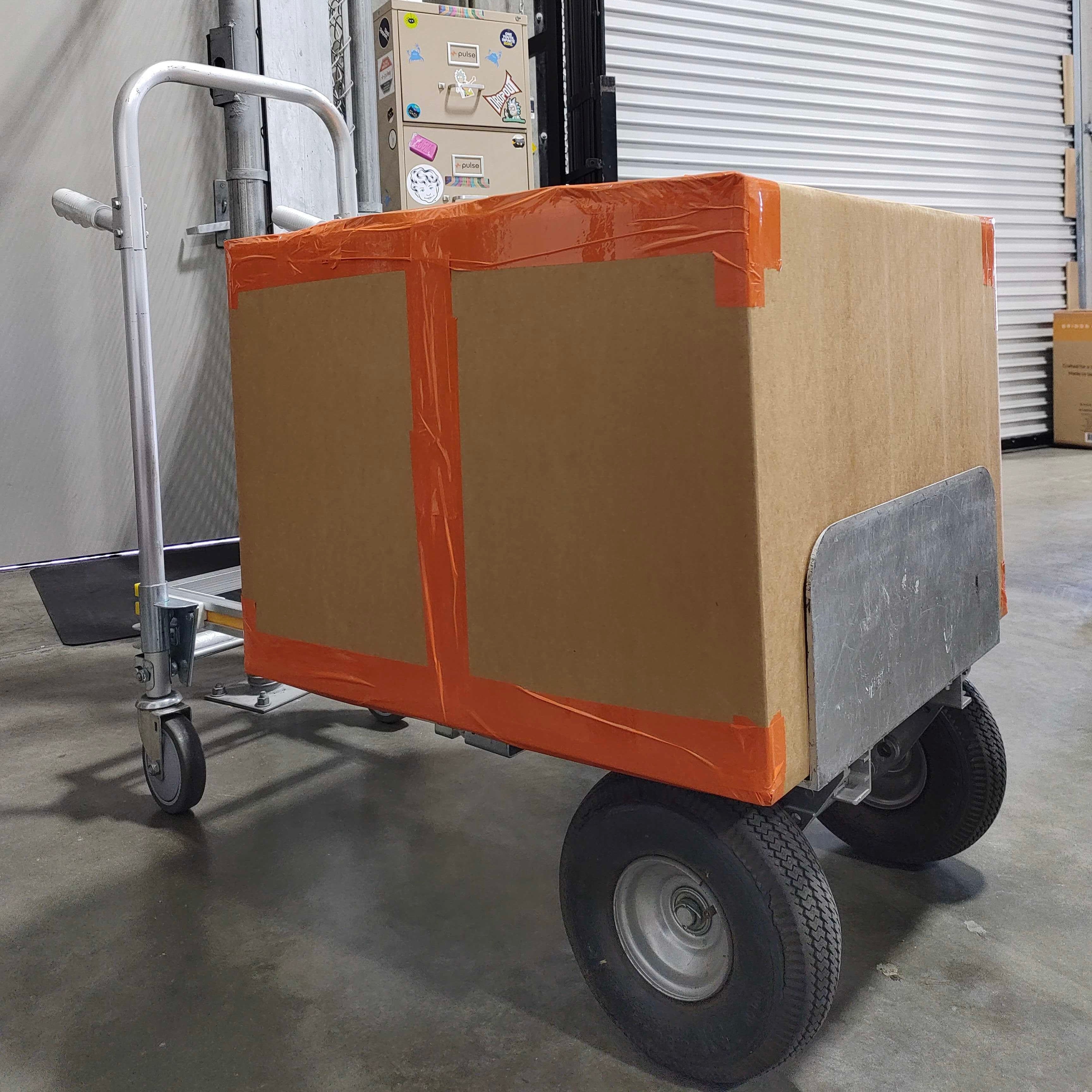 Large brown box on cart with orange tape