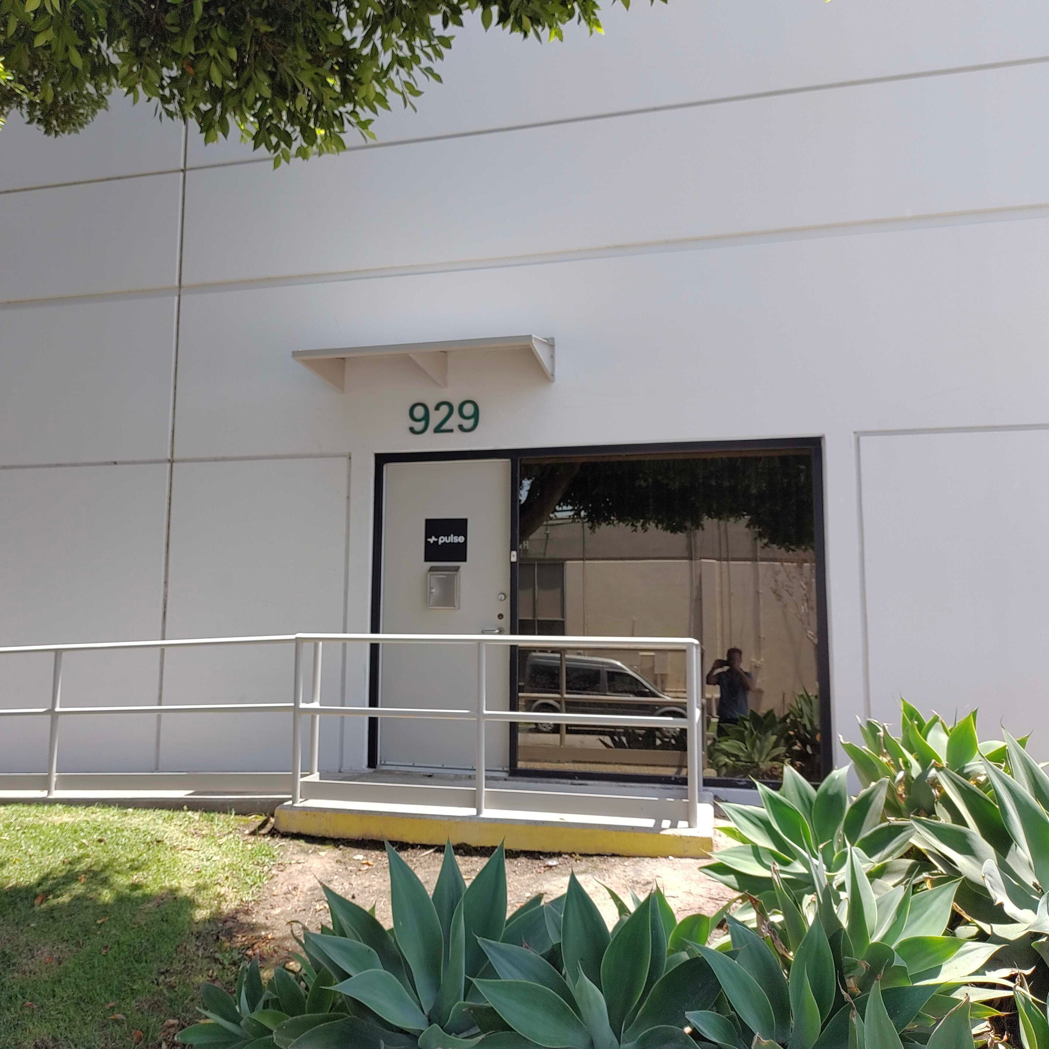 Front door of Pulse Labs with plants and greenery