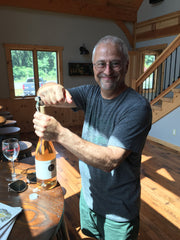 photo of owner opening wine bottle