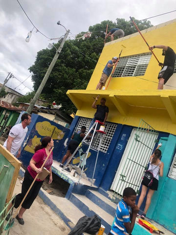 Painting a school in La Romana, Dominican Republic during the 2019 Paparazzi Passport trip service project. 