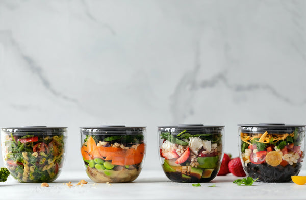 Plastic Free July: A line-up of glass containers filled with fresh food 