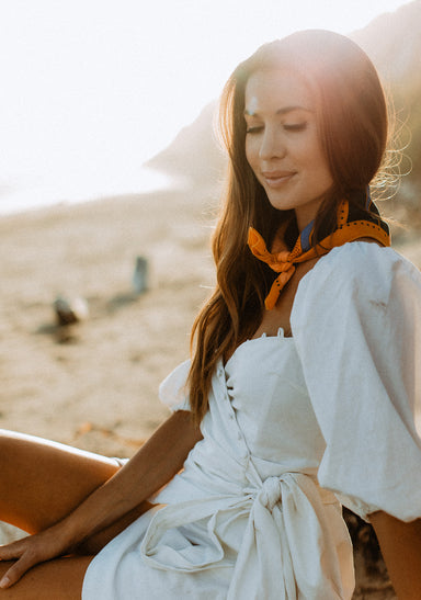 a woman sitting on a beach