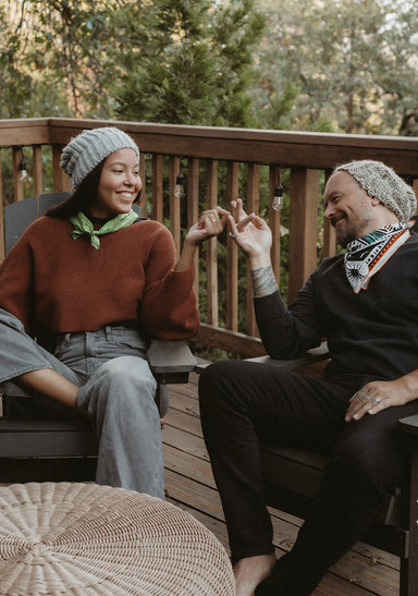 a man and woman sitting on a bench