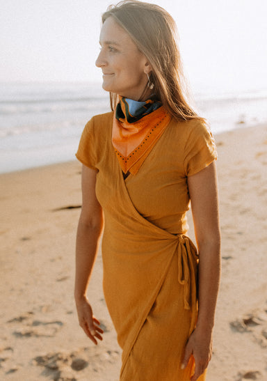 a woman in a dress on a beach