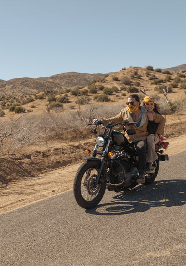 a group of people ride on a motorcycle