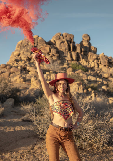 a person holding a stick with a fire in the background