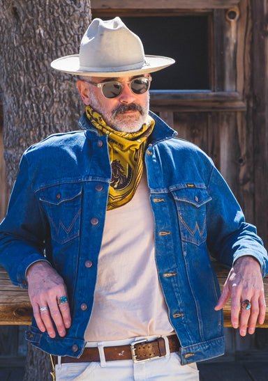 a man wearing a hat and sunglasses