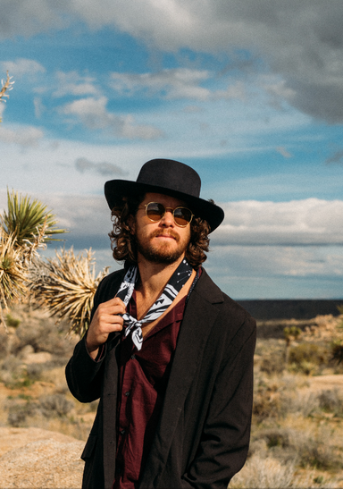 a man wearing a hat and sunglasses