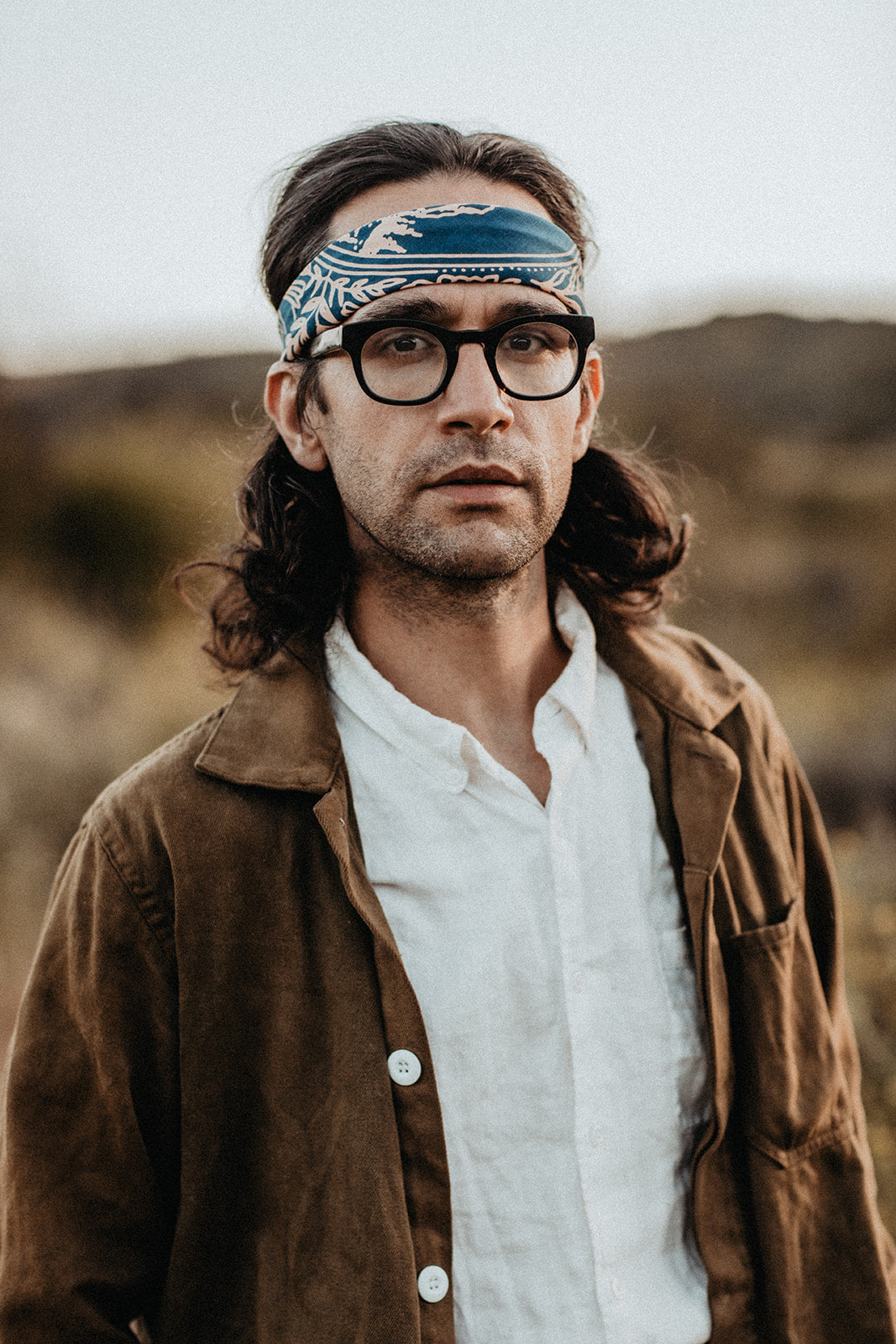 a man wearing glasses and a hat