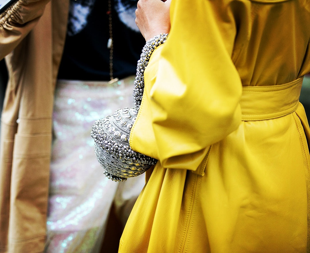 Slip Into Style influencer blogger Ellie Erdem Autumn Winter 2019 show wearing Mae Cassidy at London Fashion Week street style statement styling Silver Simi Sparkle clutch bag white tee head to toe colour Mustard yellow.