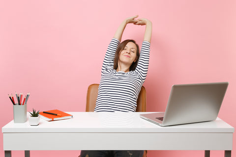 stretching at a desk