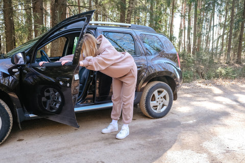 Woman stretching next to car