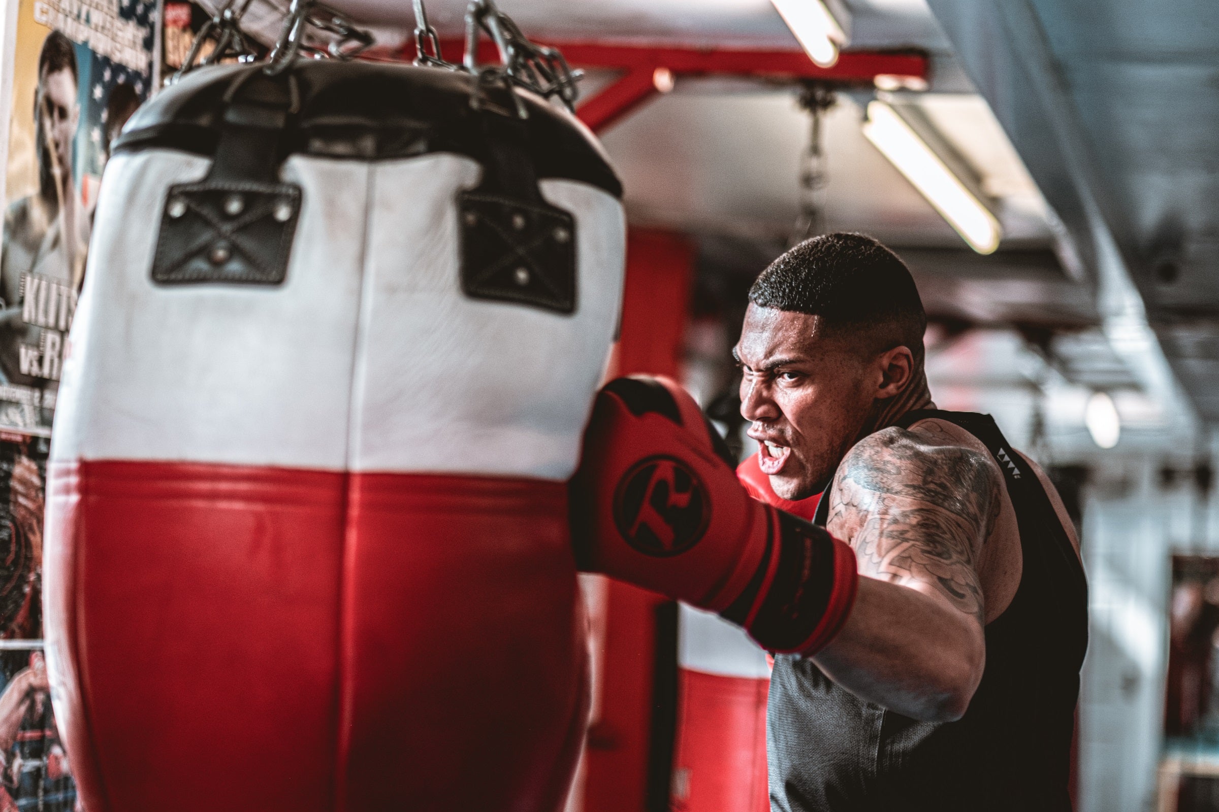 Boxer punching red and white punch bag