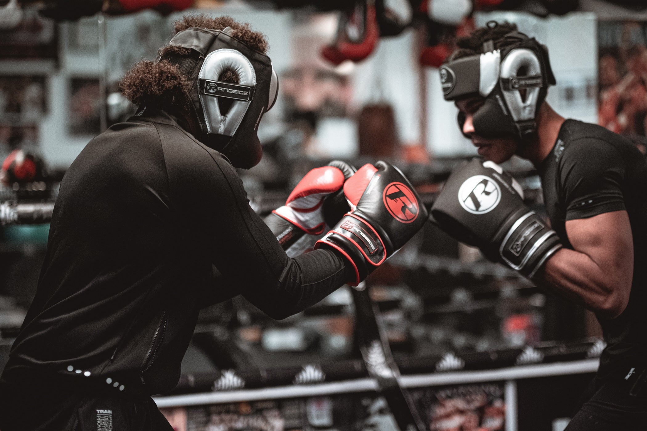 Two boxers in the ring wearing head guards