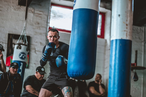 Josh Warrington boxer using blue and white punch bag