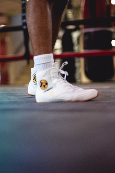 Close up of boxing boots being worn in boxing ring