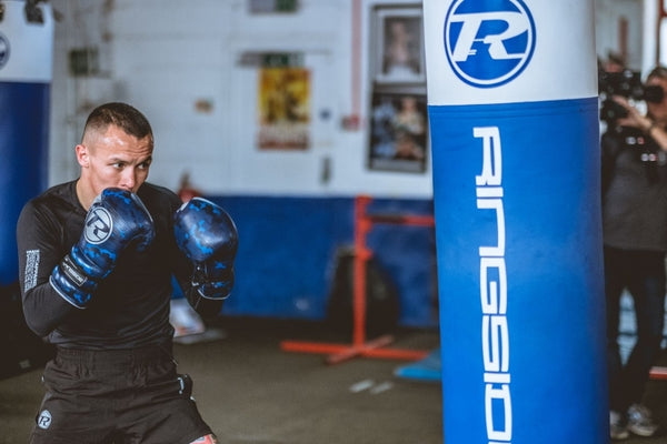 Josh Warrington boxer about to strike punching bag