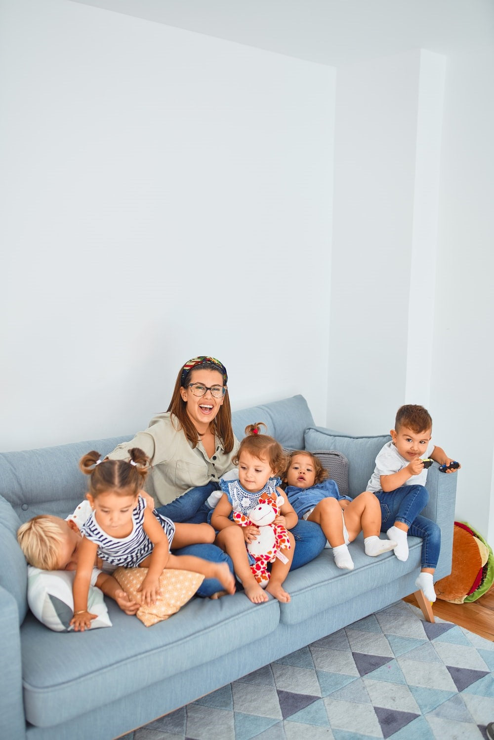Mother with children laughing on the sofa.