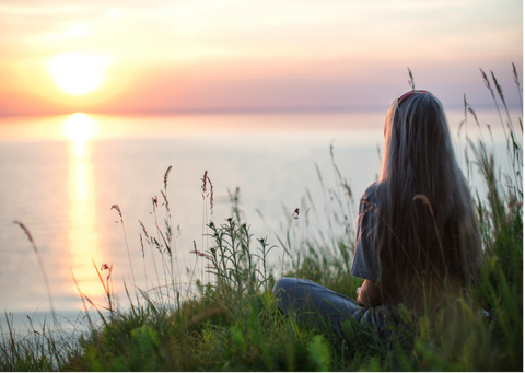 Woman sitting and looking at the beach