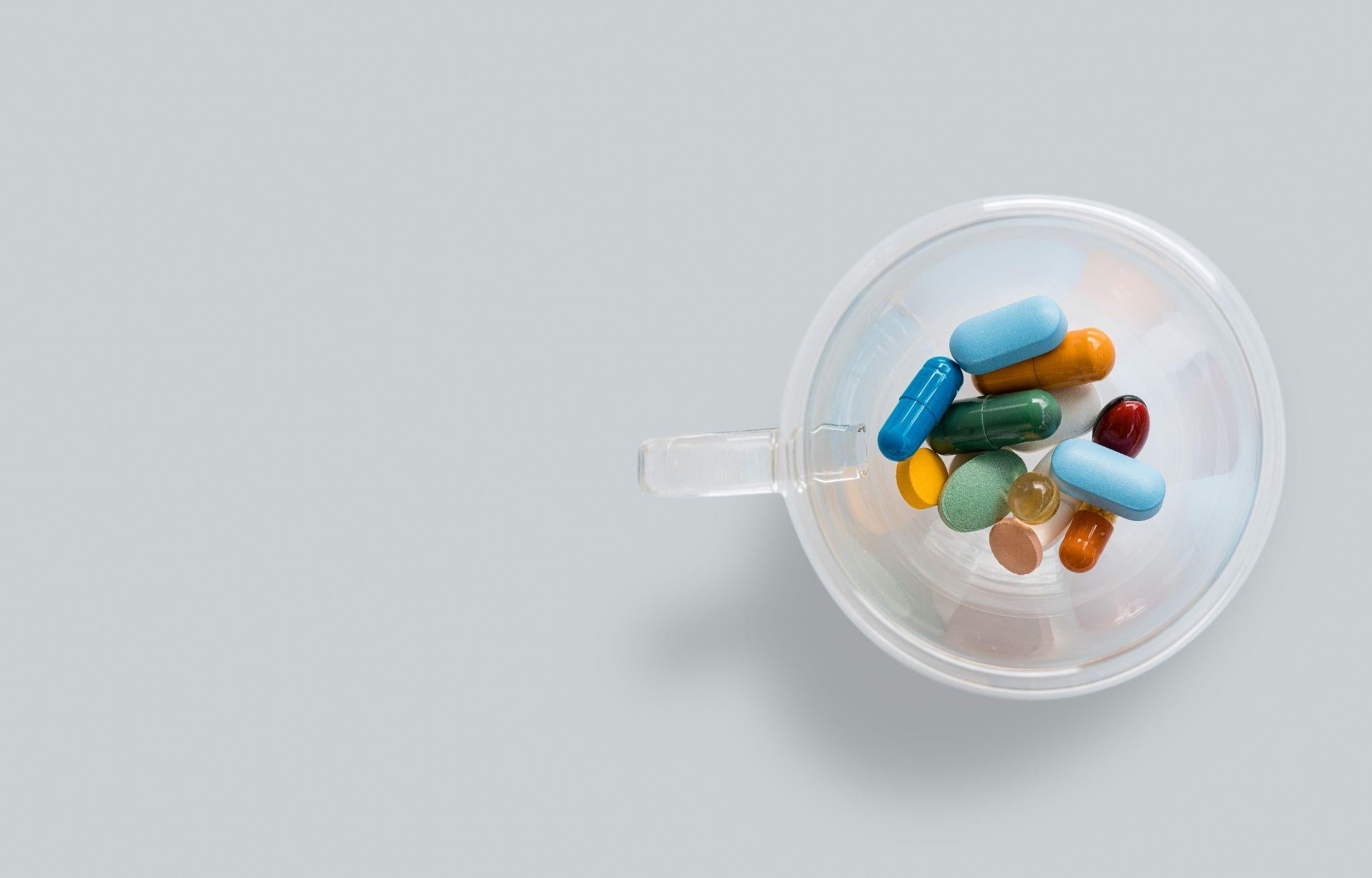 Plastic cup with pills.