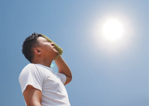 Man with towel suffering from heat stroke outdoors