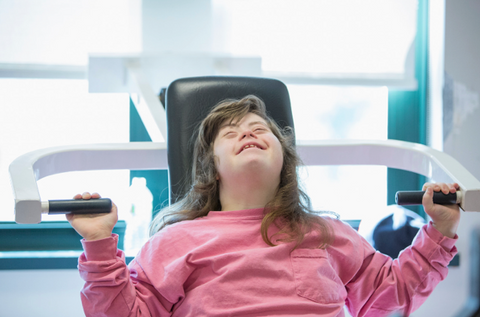 Woman with Down syndrome exercising.