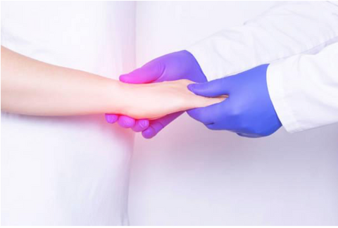 Healthcare professional holding patient's hand