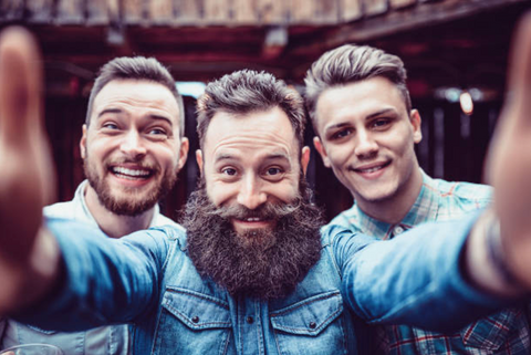 Three male friends taking a photo together