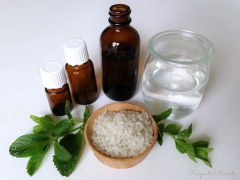 Essential oils, glass of water, and herbs