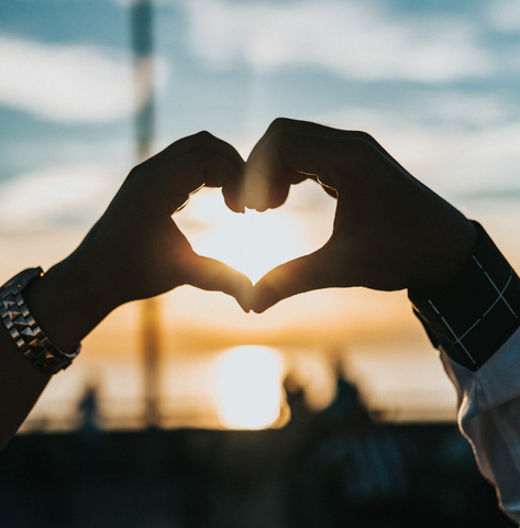 Person making a heart with their hands