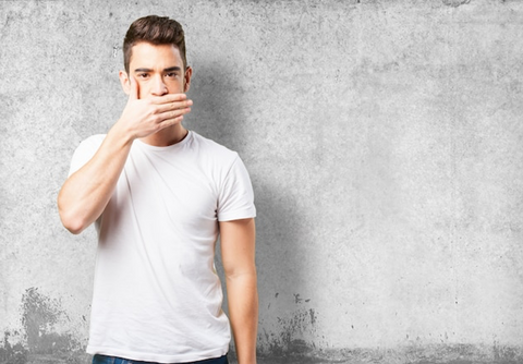 Man covering his mouth with his hand.