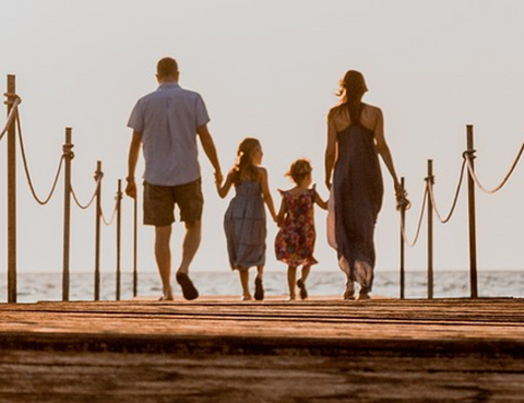 Couple with two children going to the beach.