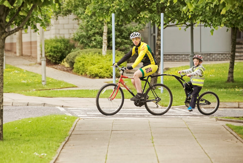 Father riding a bike with his son.