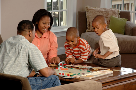 Family playing boardgames at home.