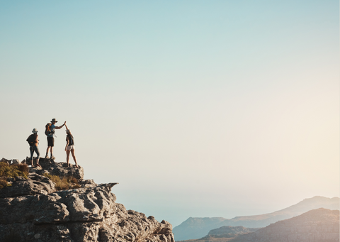 Group of friends hiking and high-fiving