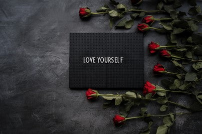 card that reads "love yourself" and roses.