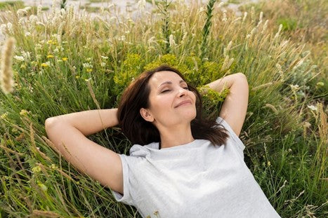 Woman lying on grass and smiling