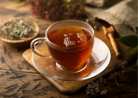Cup of herbal tea and herbs.