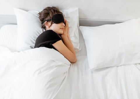 Woman sleeping in bed.