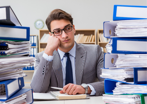 Man at work surrounded by files