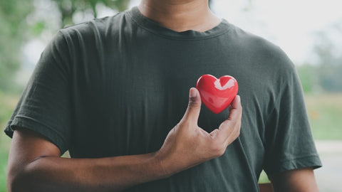 Man holding red heart.