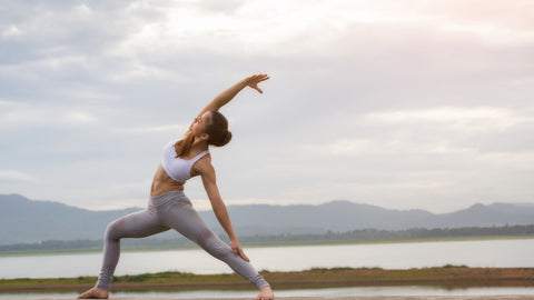 Woman practicing yoga outdoors.