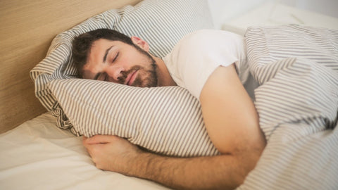 Man sleeping in bed.