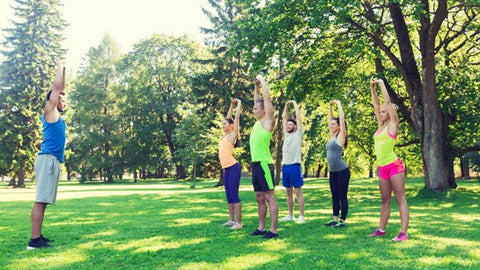 Group of people exercising outdoors at a park