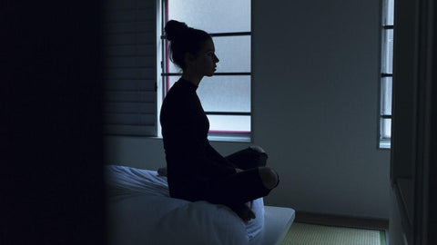 Woman sitting on bed