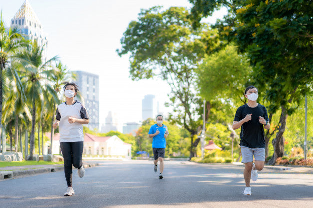 People jogging while wearing masks