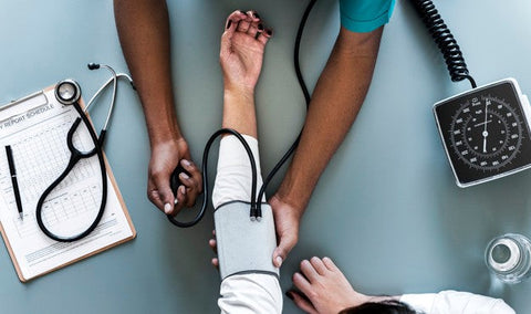 Healthcare professional measuring patient's blood pressure