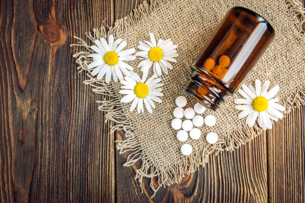 Homeopathic remedy and chamomile flowers.