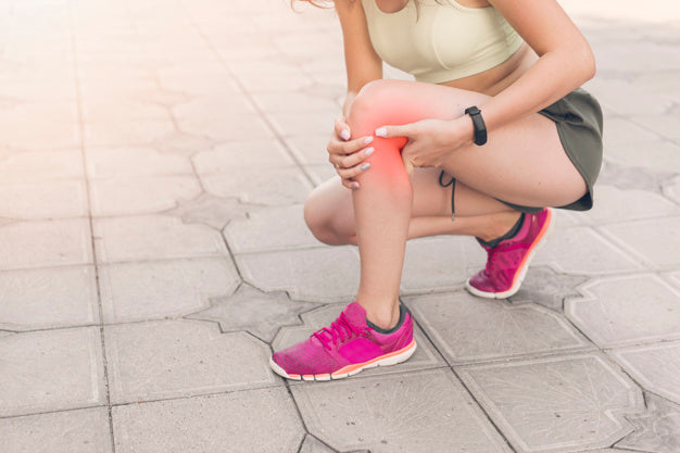 Woman suffering from knee pain.